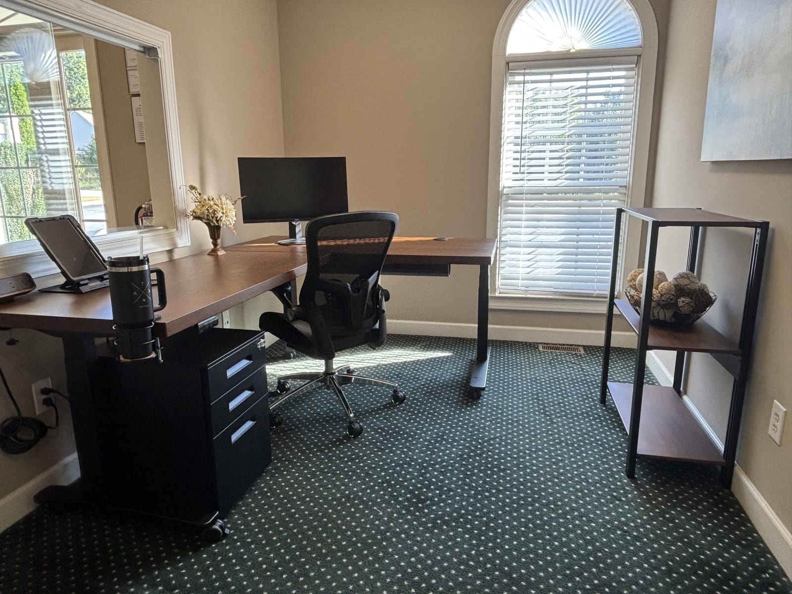 The reception desk, office chair, and Sequence Shelving unit together in the room, showing how the desk and shelving are laid out relative to each other.