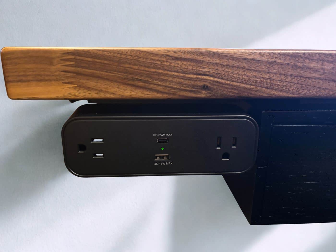 UPLIFT V3 under-desk power strip with USB-C PD 65W and USB-A QC 18W charging ports mounted beneath walnut desktop